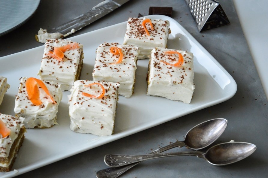 Flere stykker gulerodskage med protein str p et fad, klar til servering.