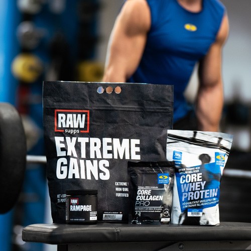 En tjej sitter p en bnk p gymmet med produkter frn Core i knt och bredvid sig.